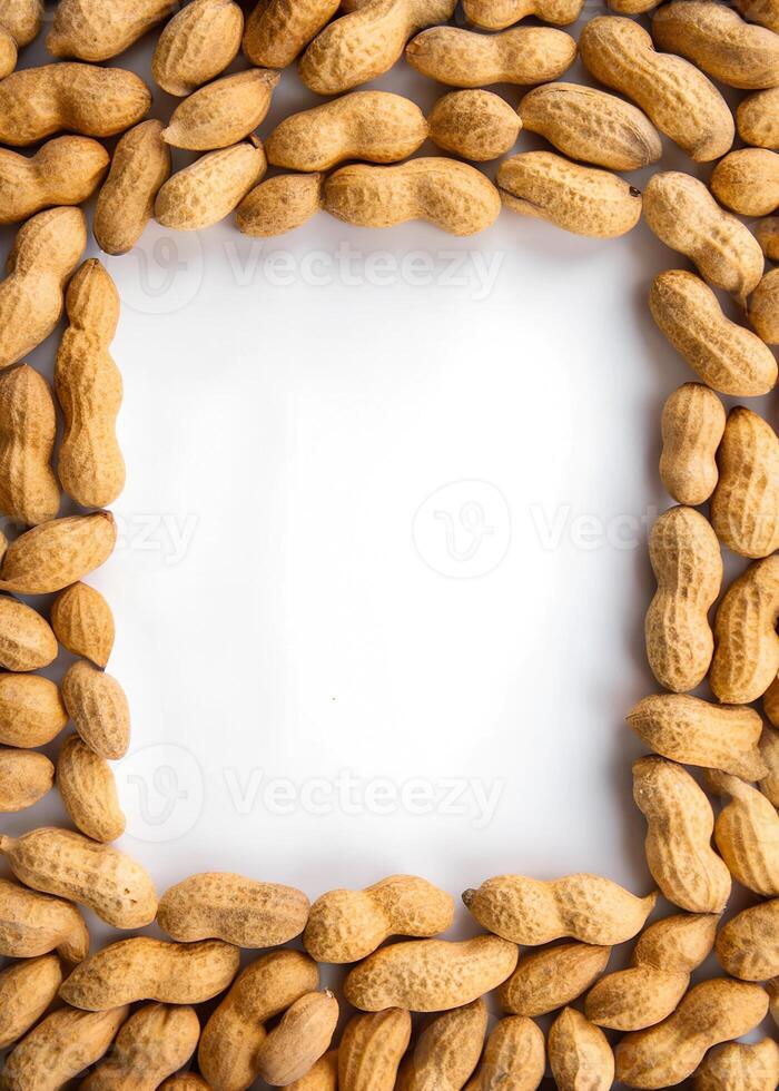 peanuts are arranged in a square frame on a white background photo
