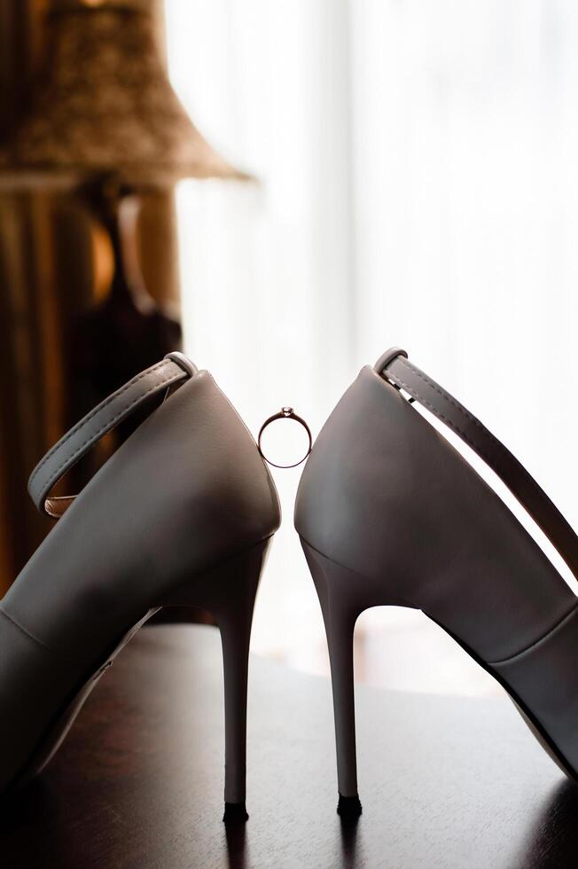 Beautiful gold diamond ring and high heels photo
