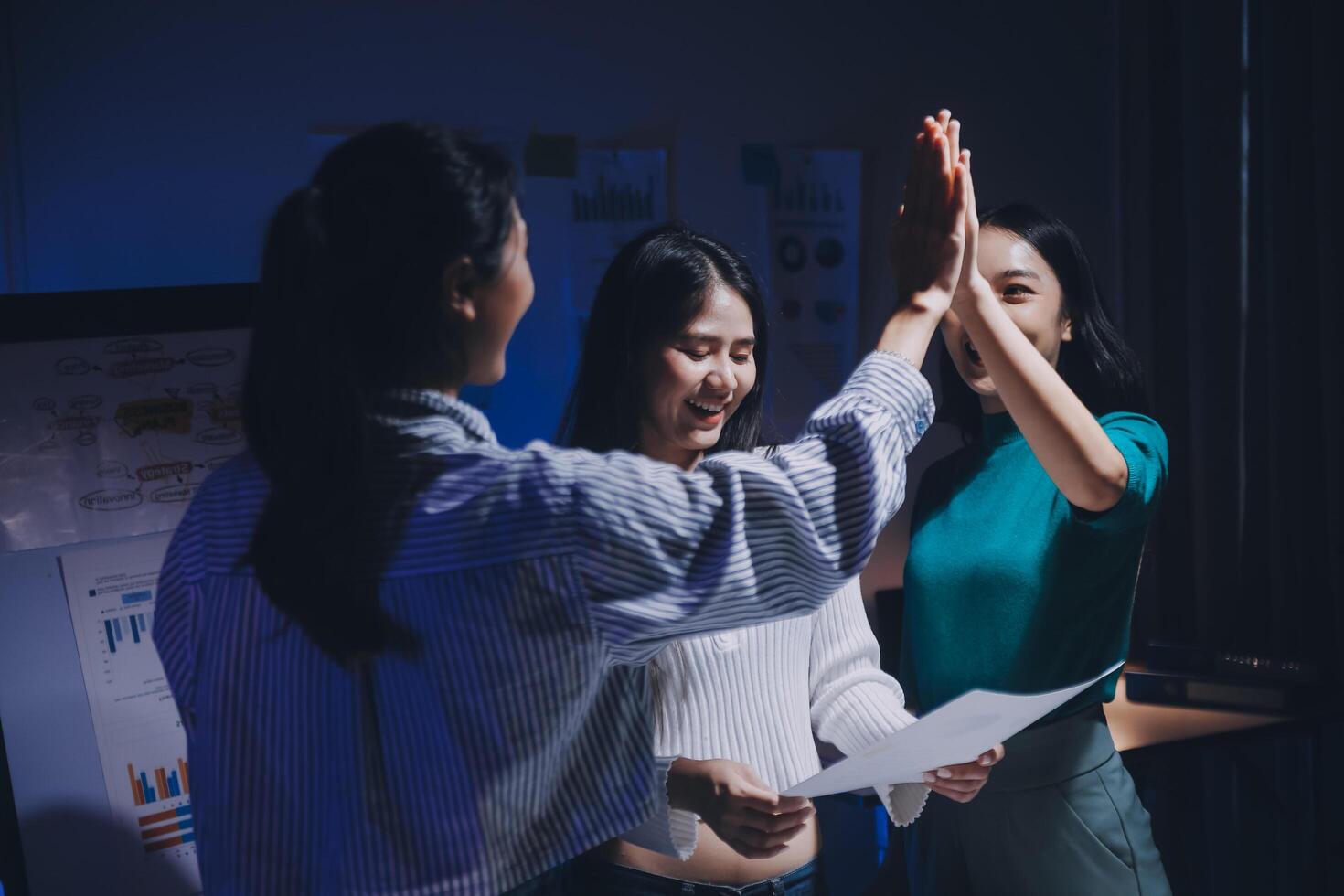 Three women giving high five to each other photo