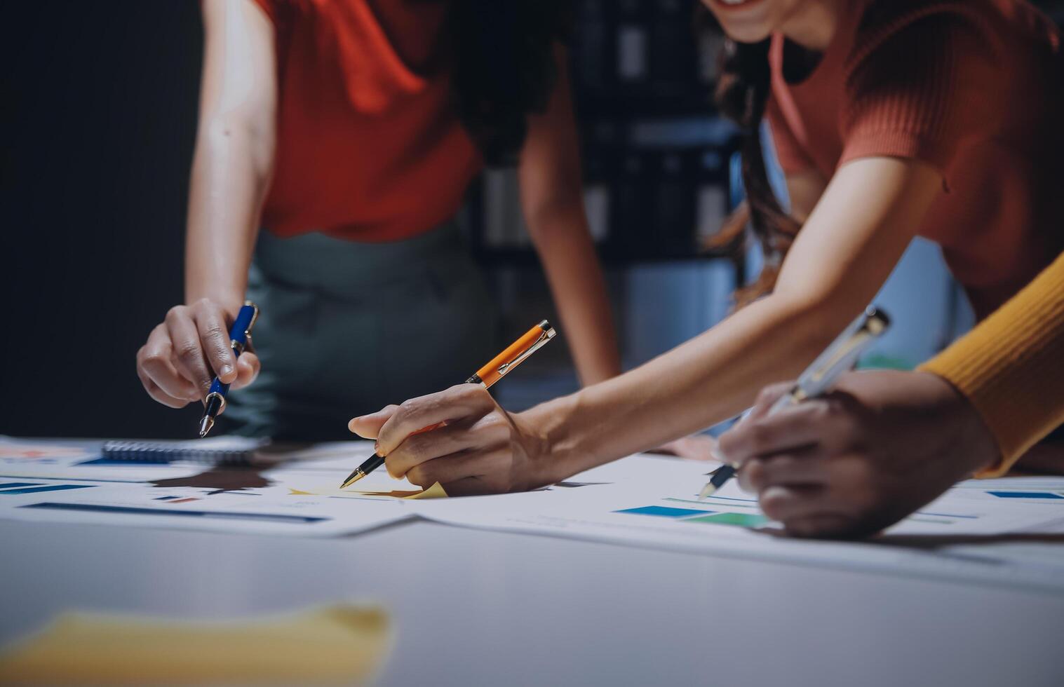 Three people working on a project at a table photo
