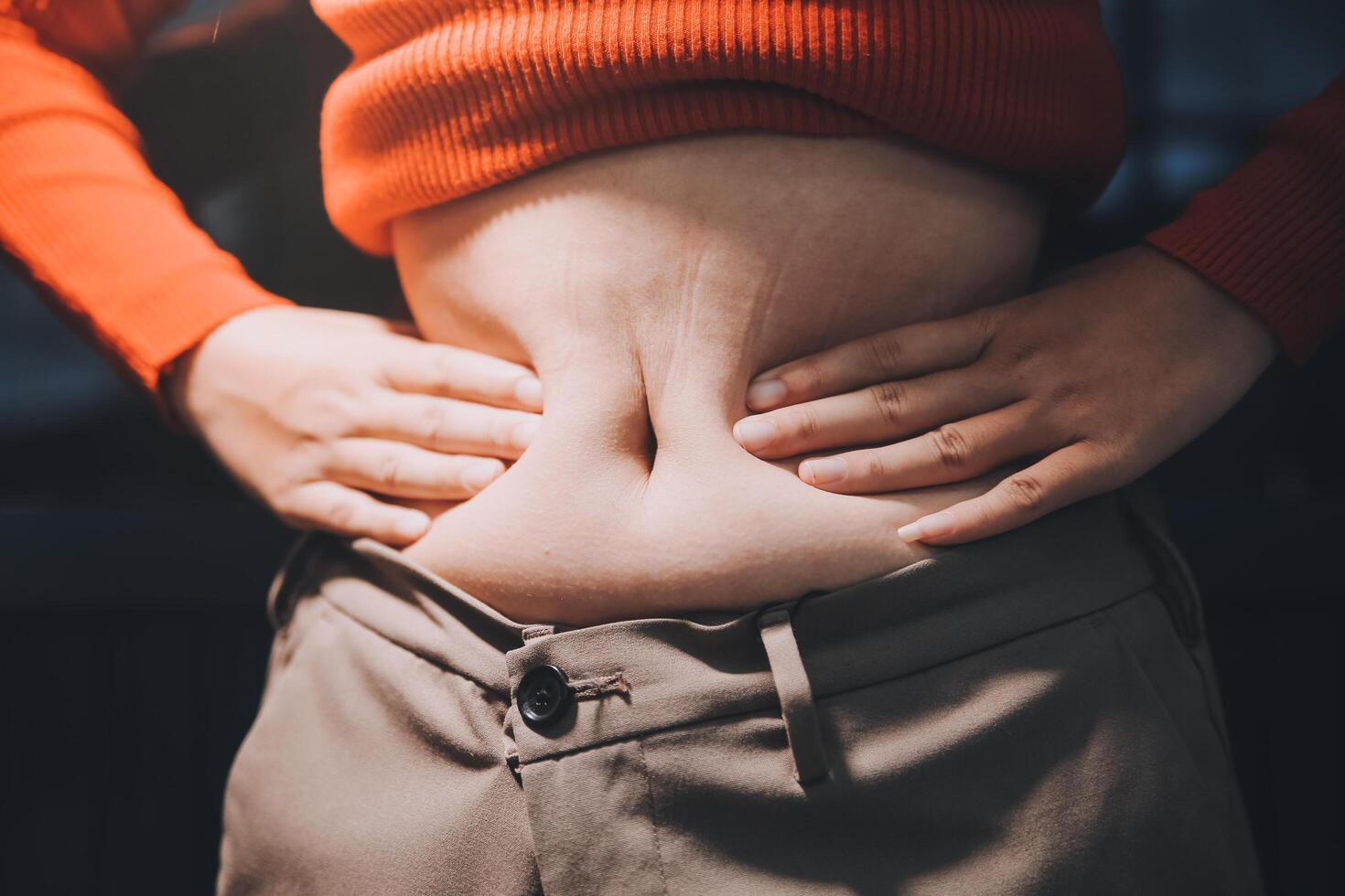 A woman with her hands on her stomach photo