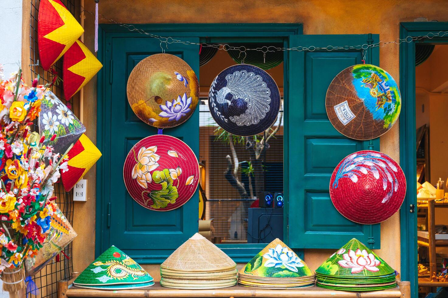 Vietnamese painted hats Non La are sold for tourists as souvenirs. Da Nang, Vietnam - November 30, 2024. photo