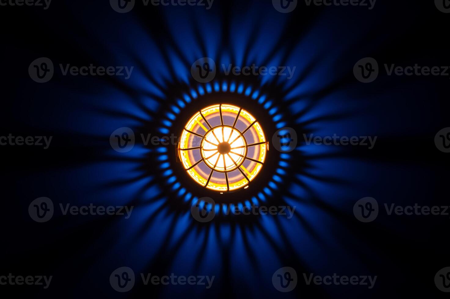 Top view of golden lantern with shadow on dark blue background photo