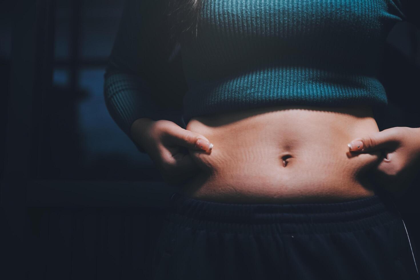 A woman with her hands on her stomach photo