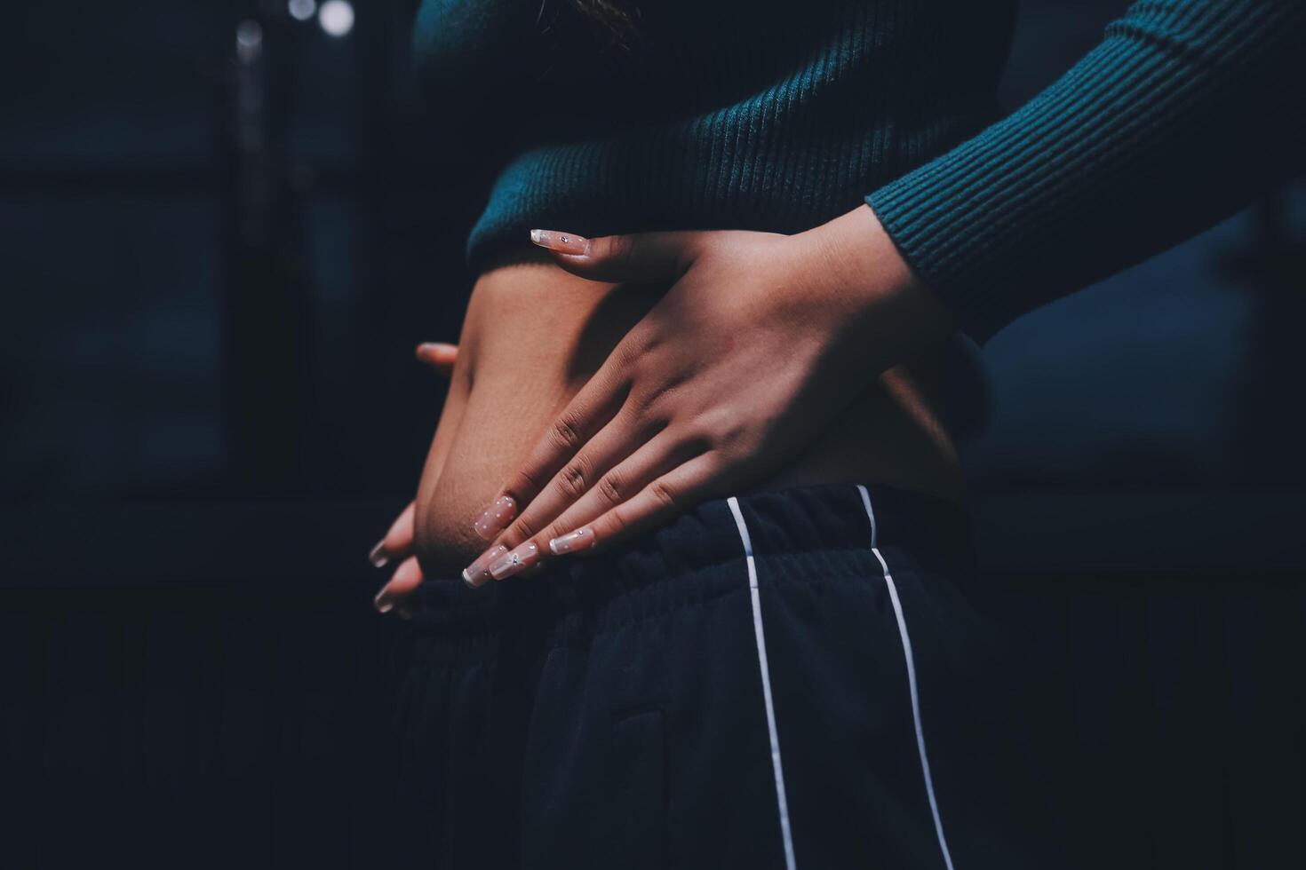 A woman with her hands on her stomach photo
