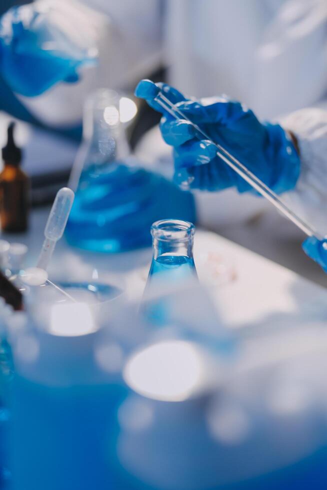A person in a lab coat is holding a test tube photo