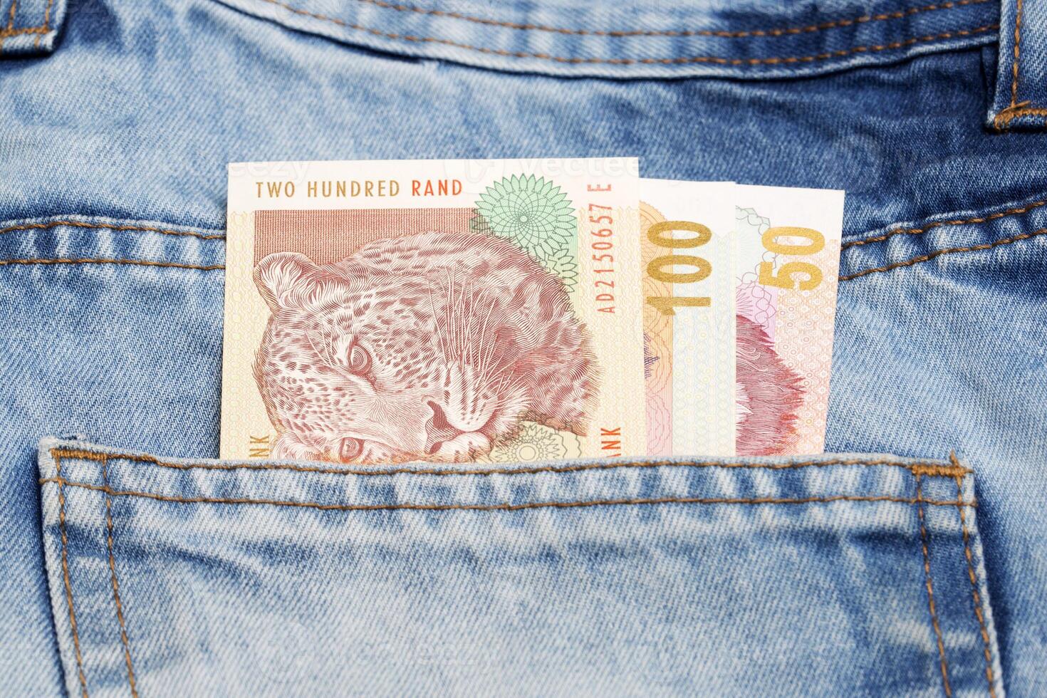 Old South African money - Rand in the pocket of blue jeans photo