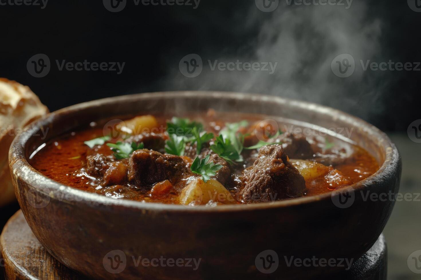 Bowl of Hungarian goulash, rich with beef, vibrant paprika, and chunks of perfectly cooked potatoes, served in a rustic, dark setting. photo