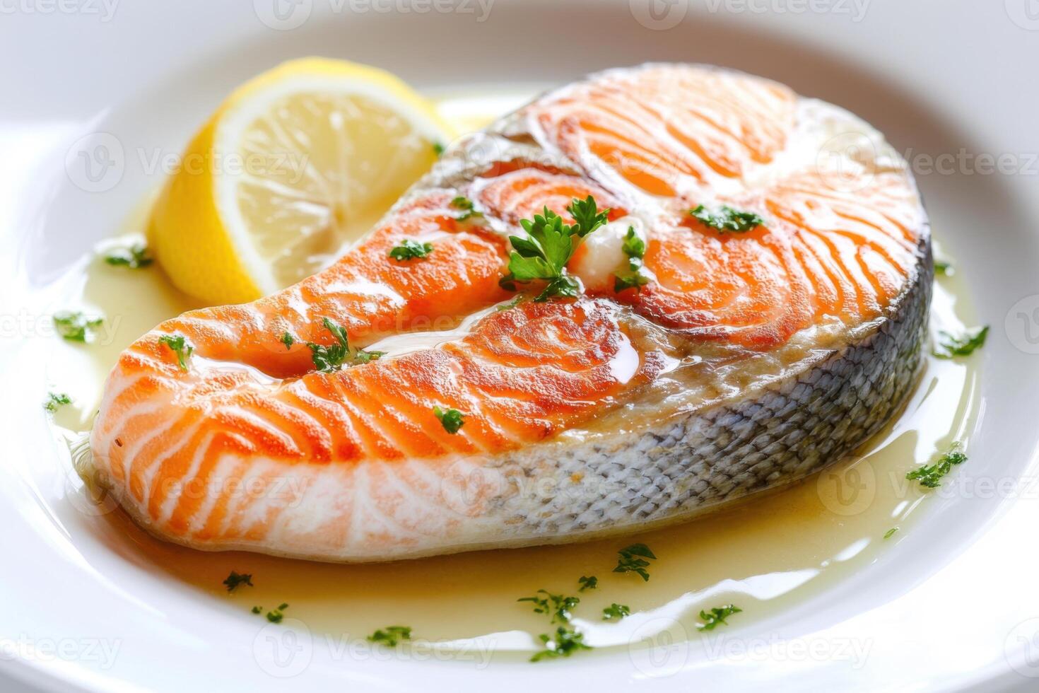 A perfectly seared salmon steak, glistening with lemon butter sauce, served on a white plate. photo