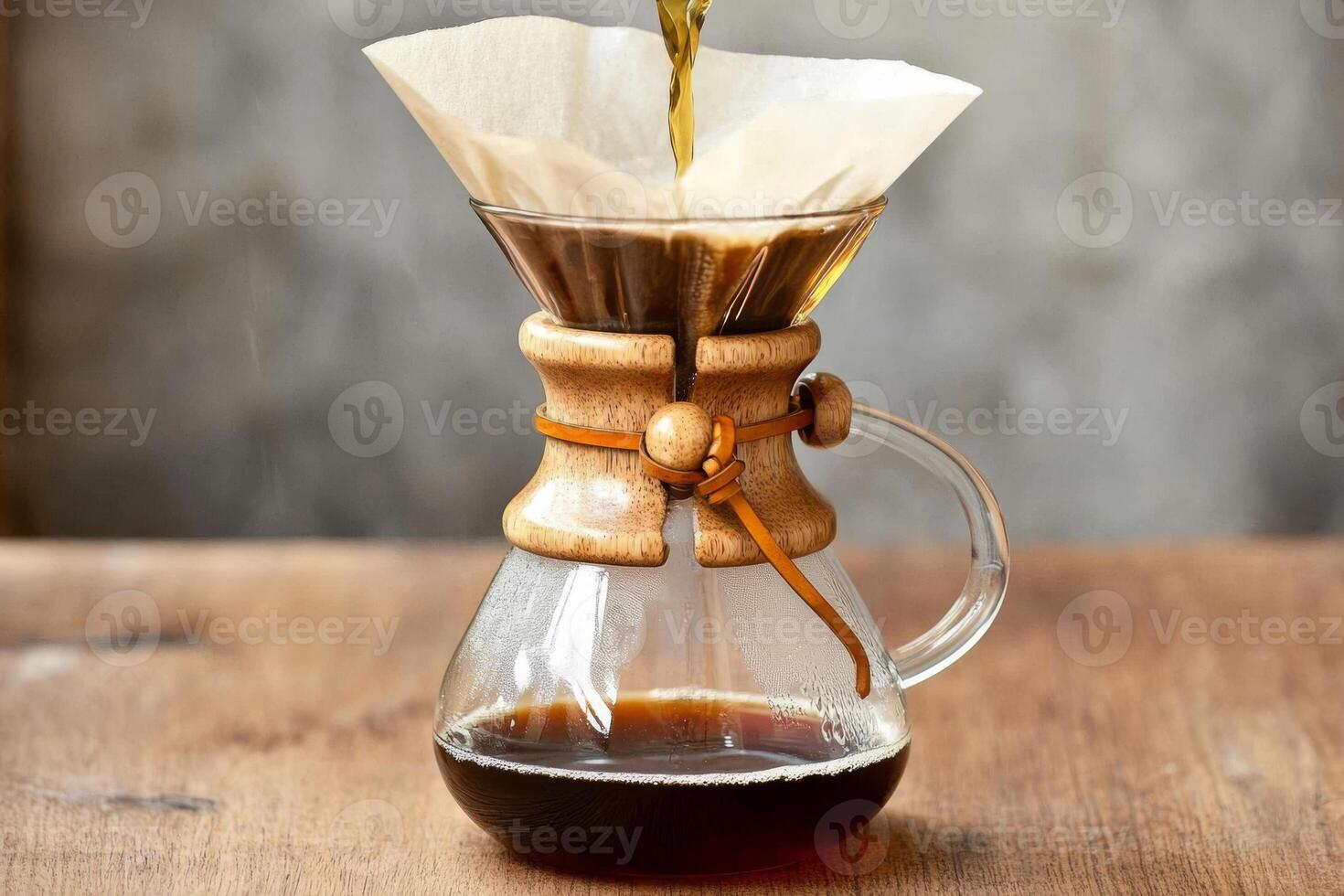 Brewing drip filter coffee on wooden table photo