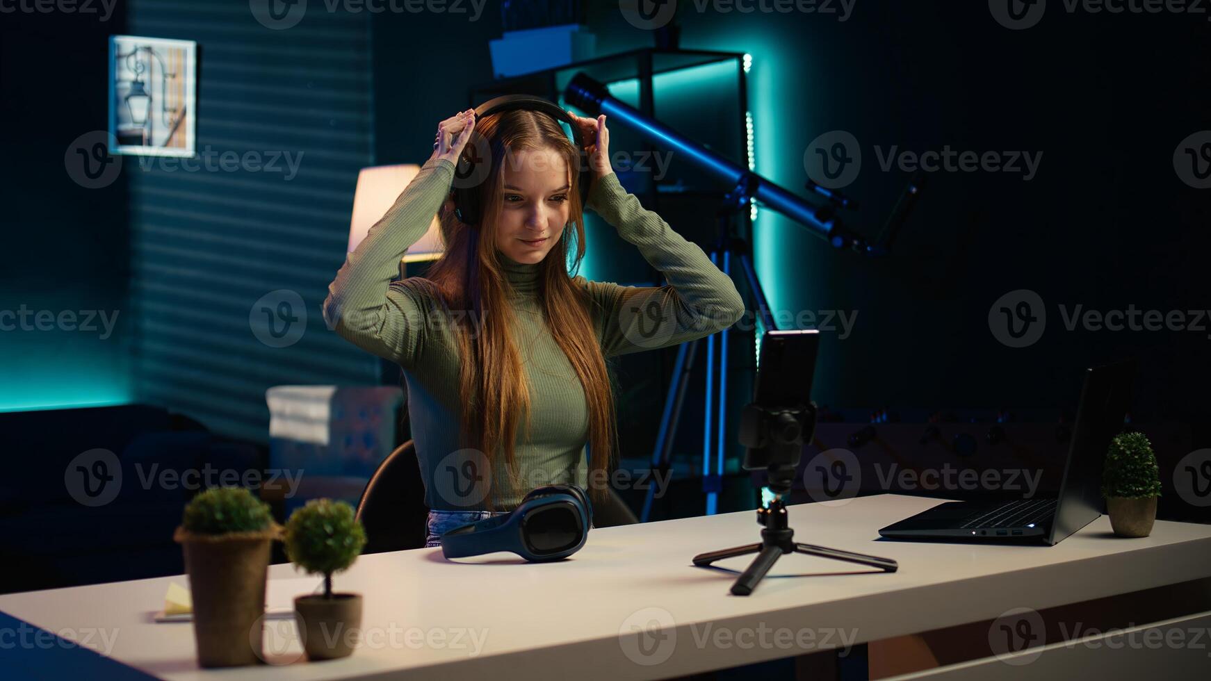 Young content creator films review of book, browsing through pages, presenting synopsis to audience. Internet star sponsored by publisher to show new novel release to readers, camera B photo
