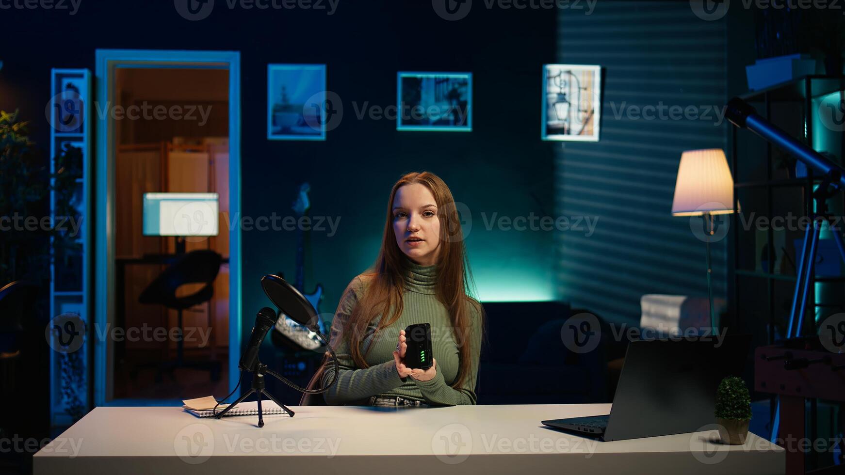Tech expert holding V mount battery ensuring ample power to fuel production equipment, showing it to subscribers. Gen Z influencer vouching for professional charging device brand, camera B photo