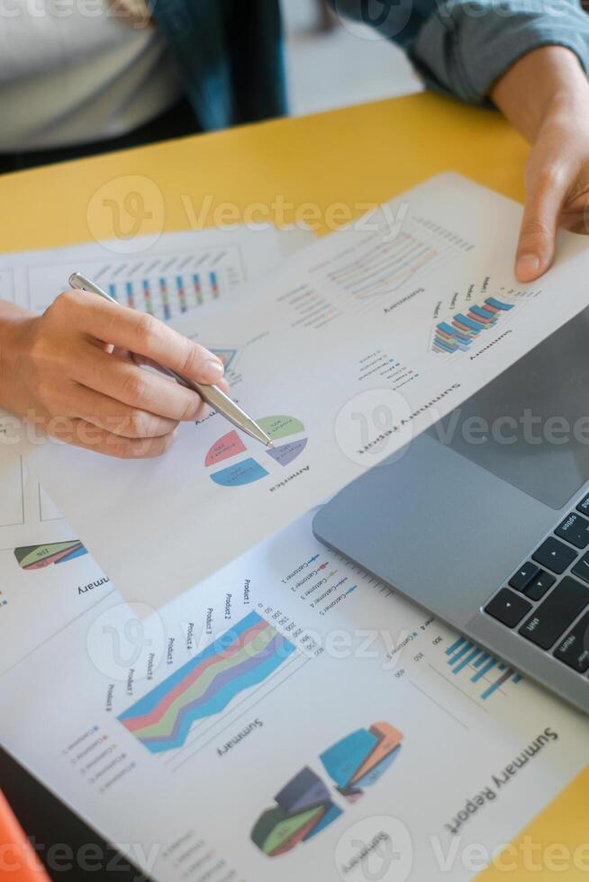 Close-up of hands reviewing financial charts and graphs, highlighting business analysis and data interpretation. photo