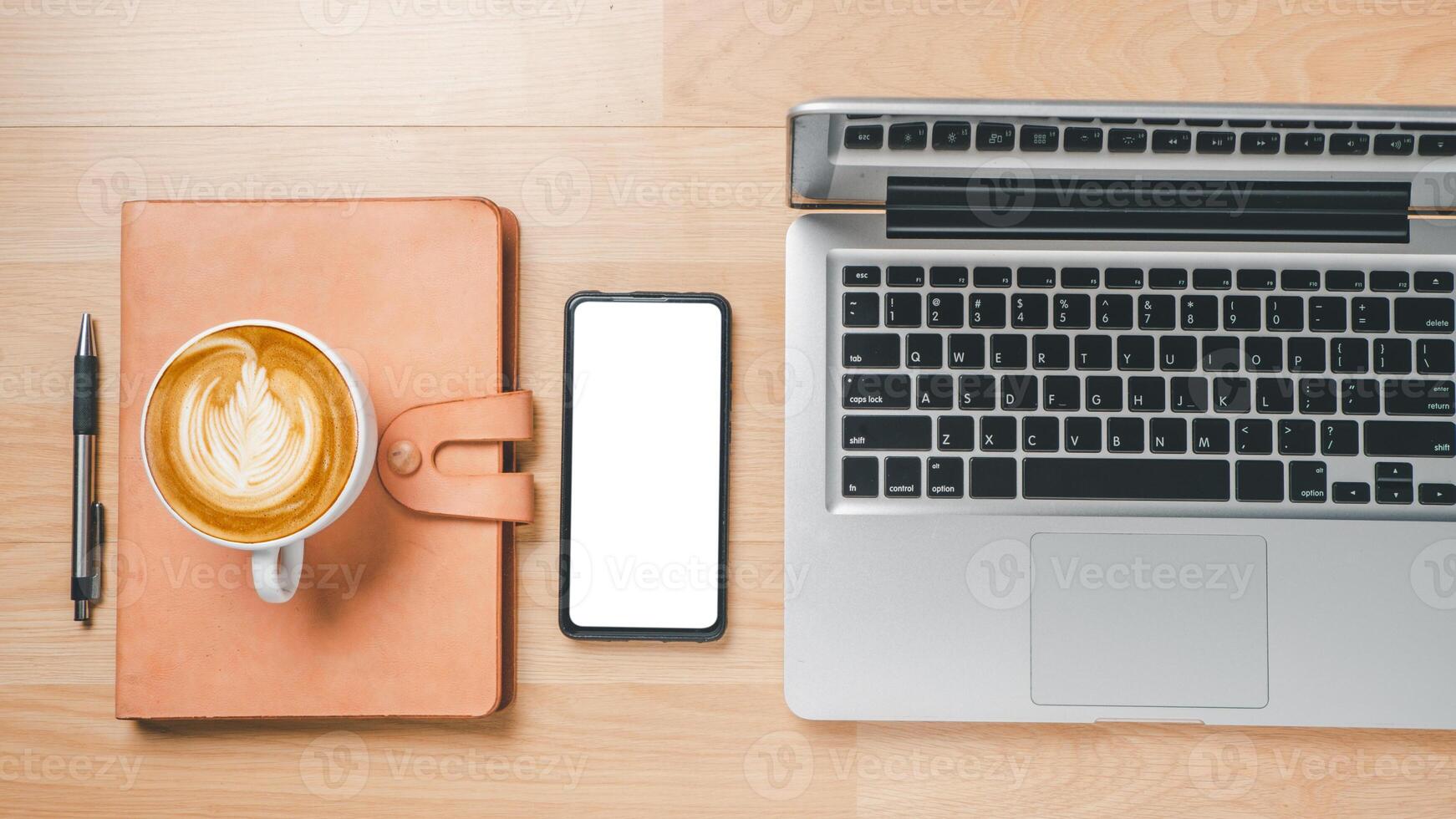 Office desk workspace with blank screen smart phone, laptop computer, notebook, pen and cup of coffee, Top view flat lay with copy space. photo