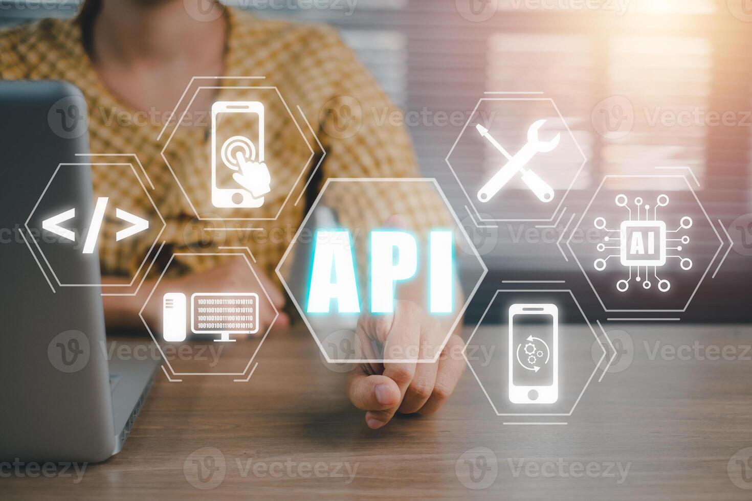 API, Application Programming Interface, Woman using laptop computer with VR screen API icon on office desk, Software development tool, modern technology, internet and networking concept. photo