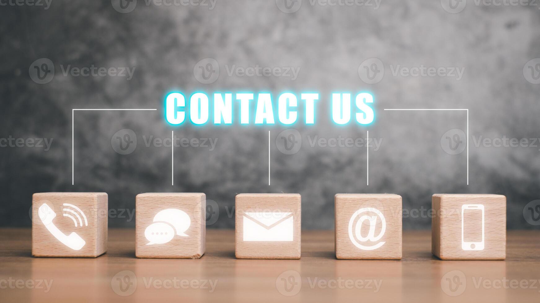 Contact us or Customer support hotline people connect, Wooden blocks with contact us icon on dark background. photo