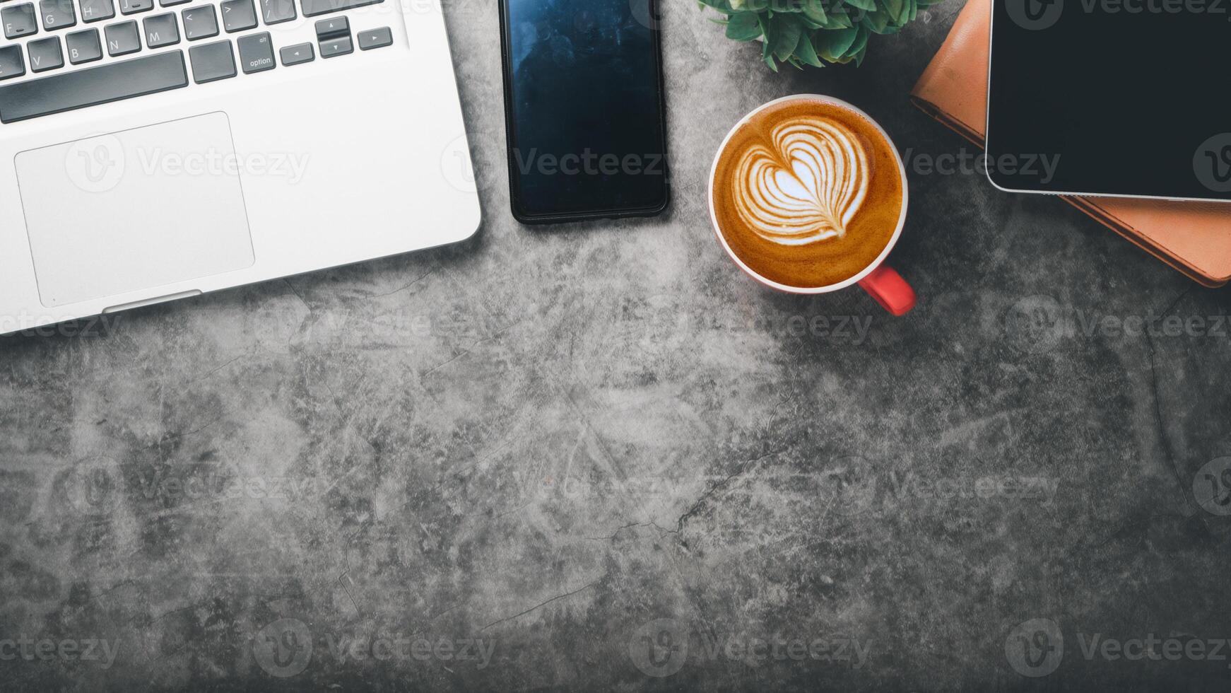 Office desk worplace with laptop computer, tablet, smartphone, notebook and cup of coffee, Top view flat lay with copy space. photo
