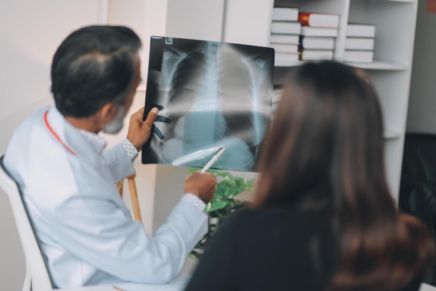 A man and woman are looking at an x - ray photo