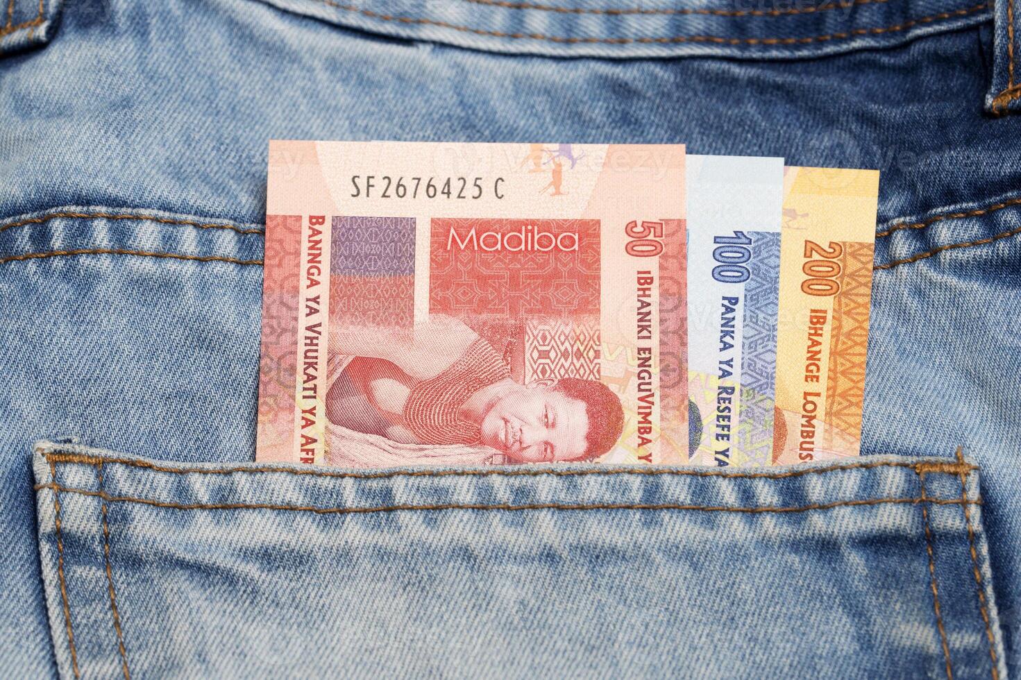 New South African money - Rand in the pocket of blue jeans photo