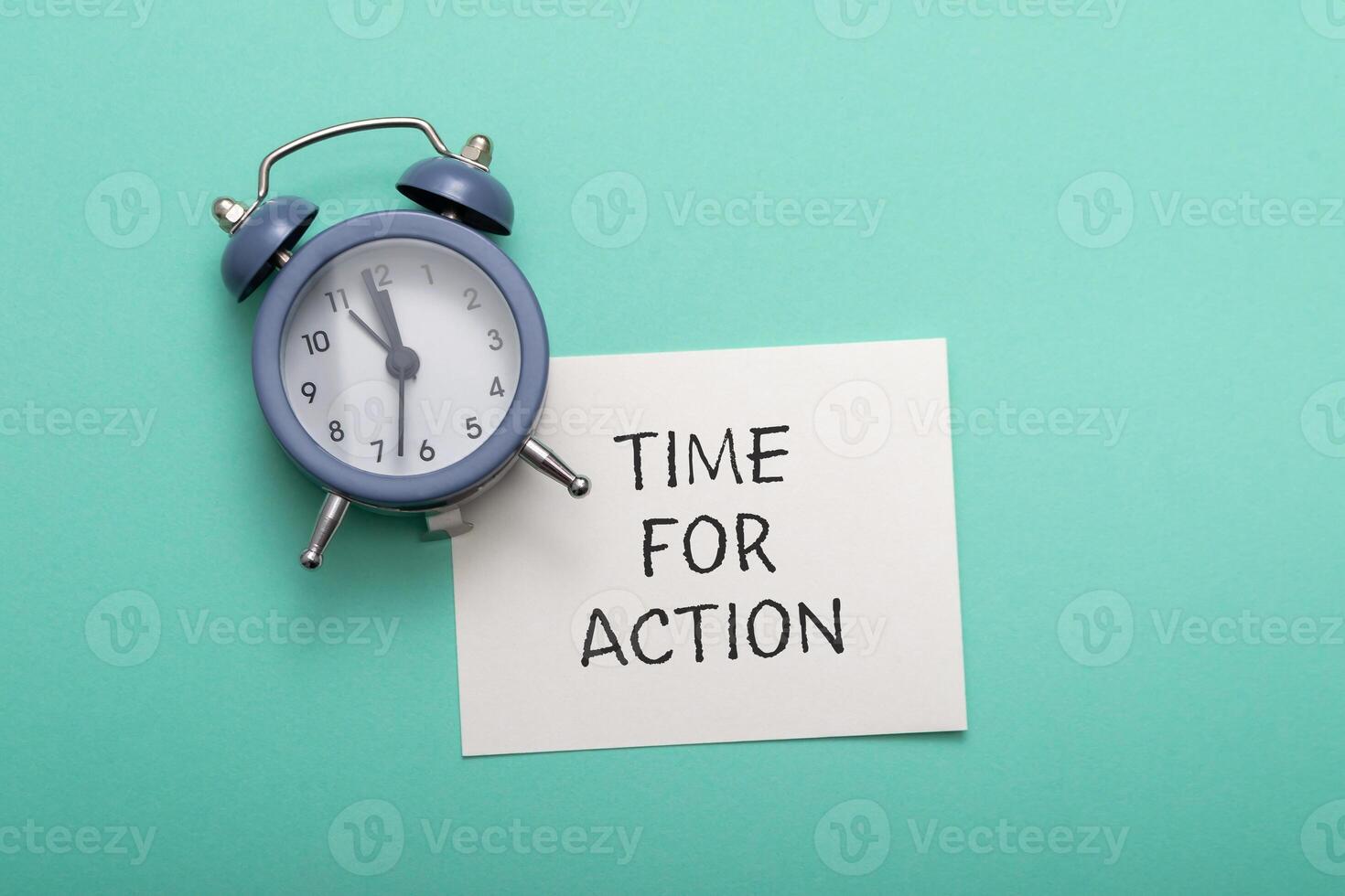 Phrase Time for Action with alarm clock on azure background photo