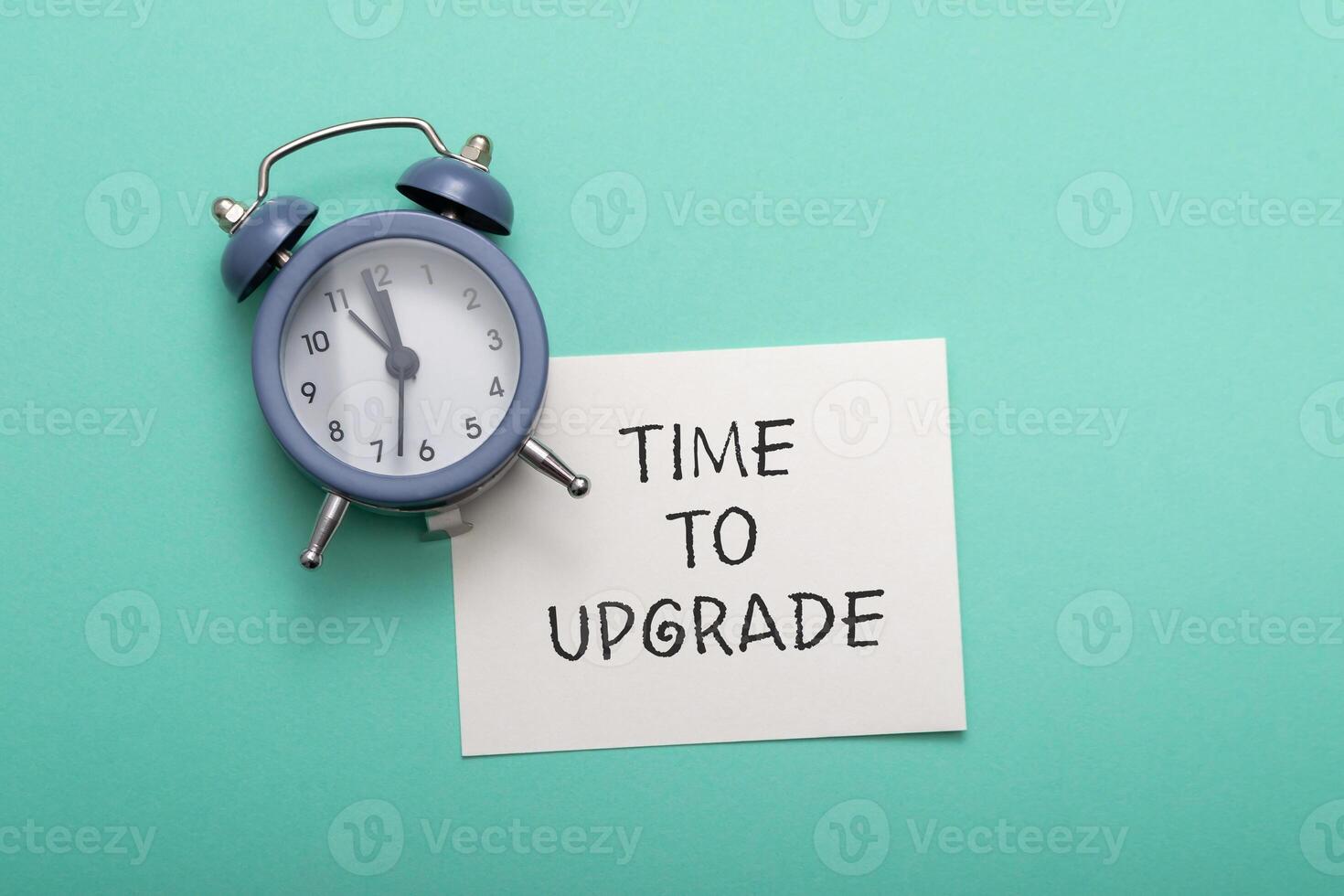Composition with text Time to Upgrade on cyan background photo
