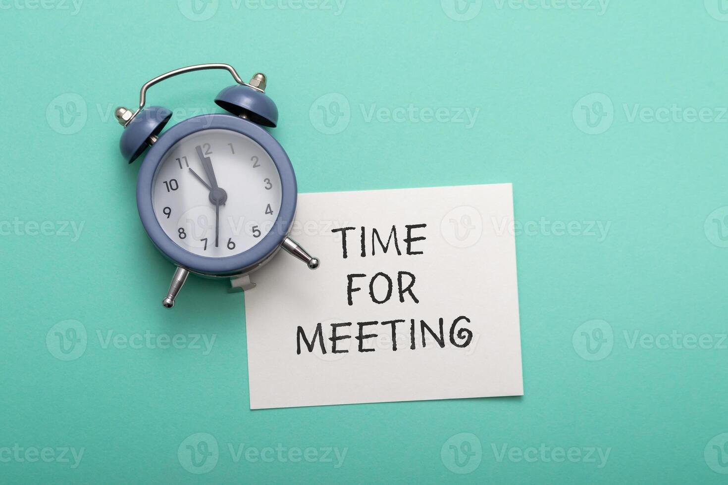 Composition with text Time for Meeting and blue alarm clock photo