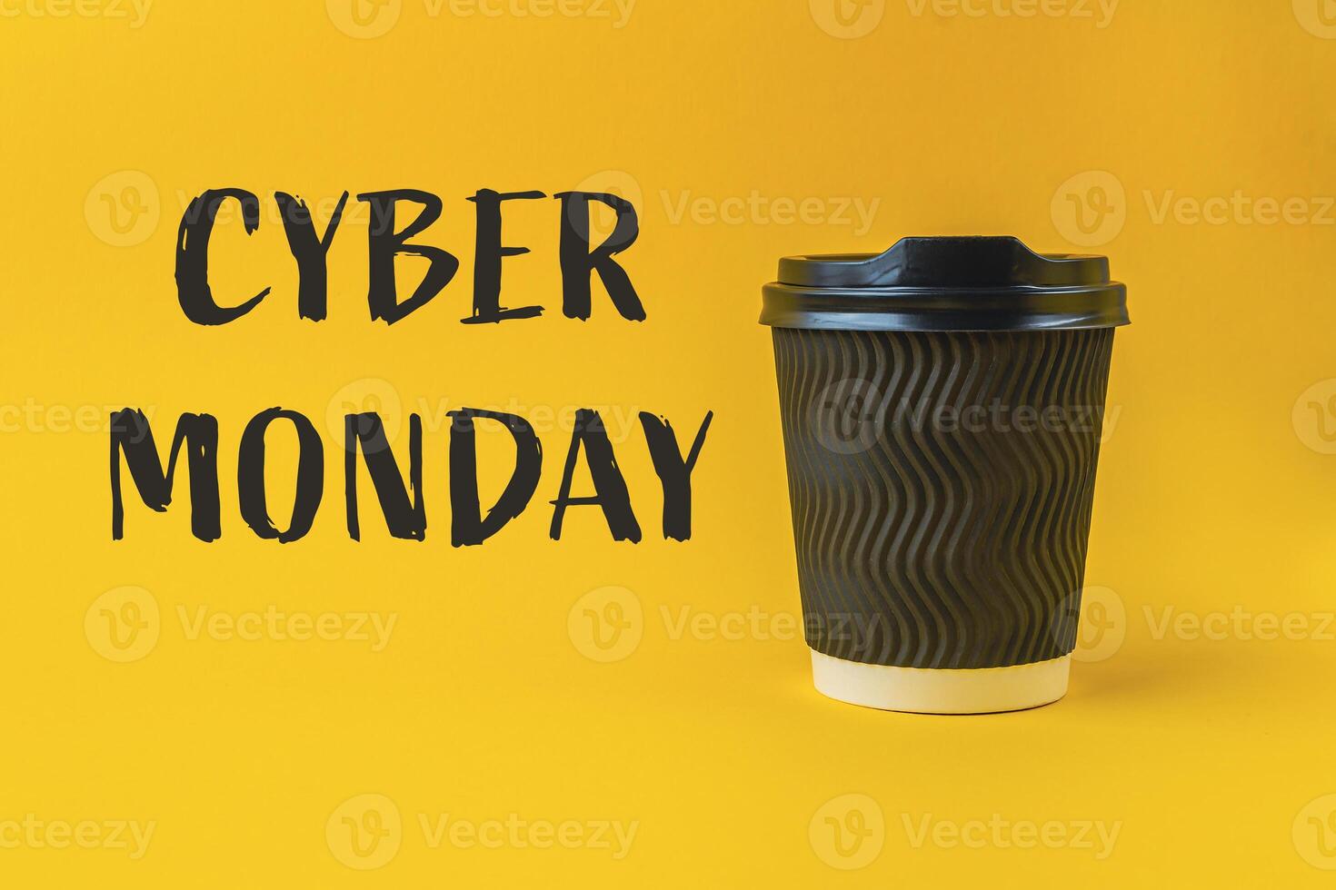A coffee cup with a black lid sits on a yellow background photo