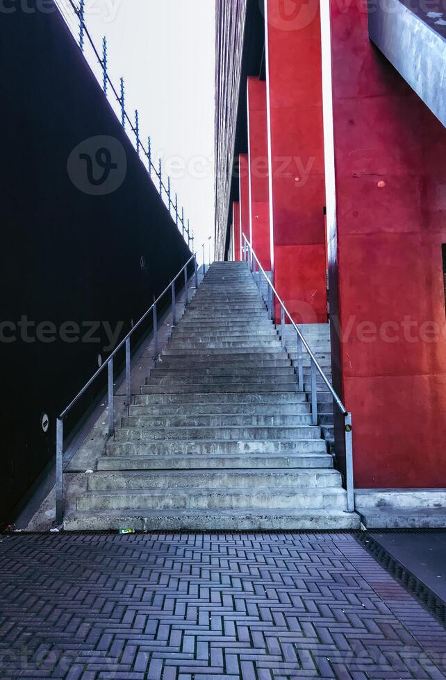 Staircase is shown in front of a red building photo