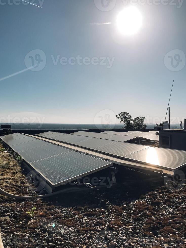 A solar panel array is installed on a roof photo