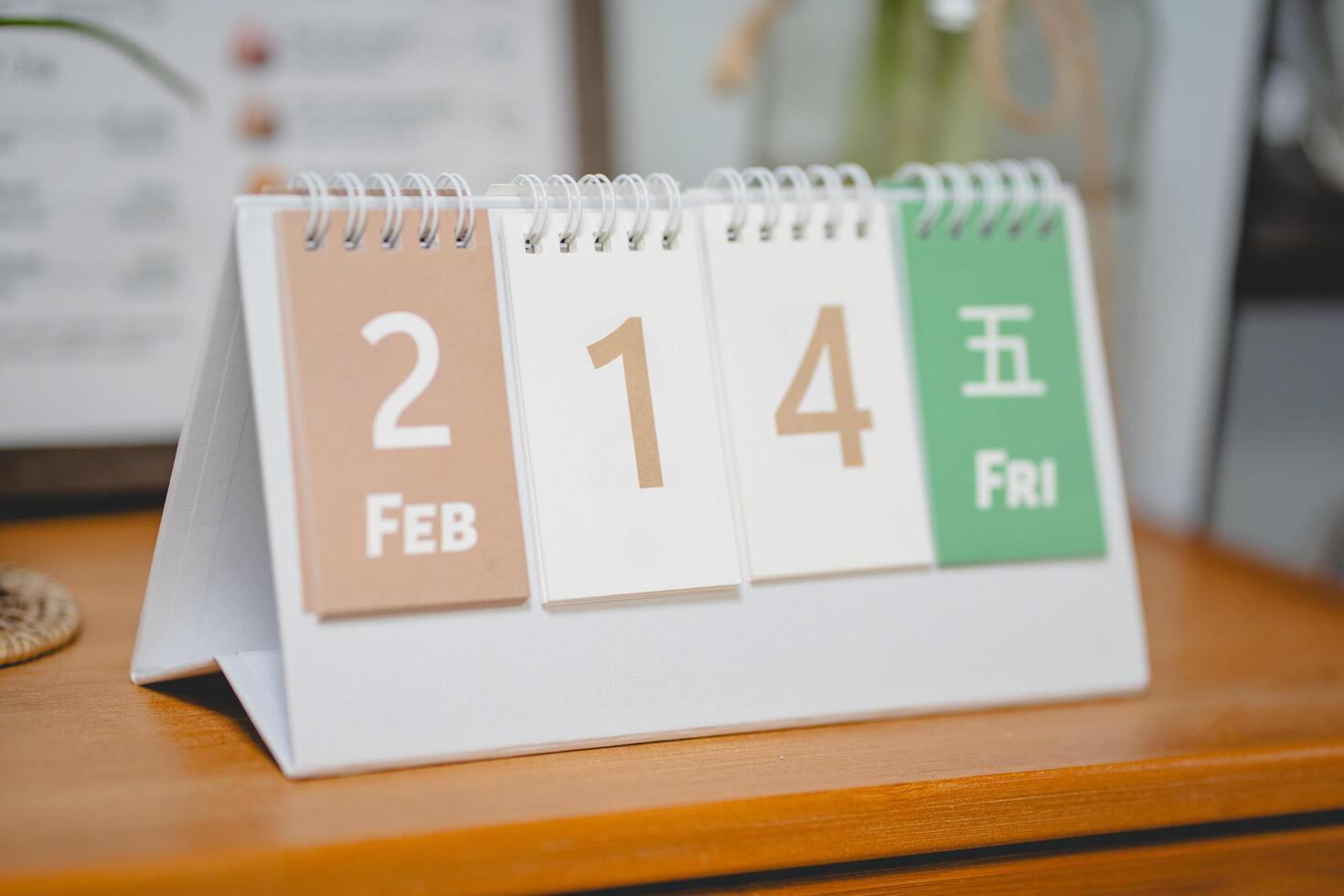 Valentines day concept. February 14 text on desk carlendar on wooden table photo