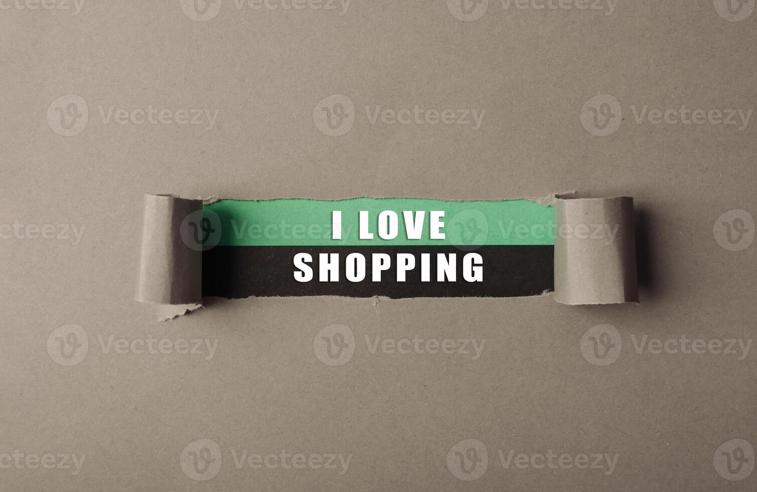 A torn piece of paper with the words I love shopping written on it photo
