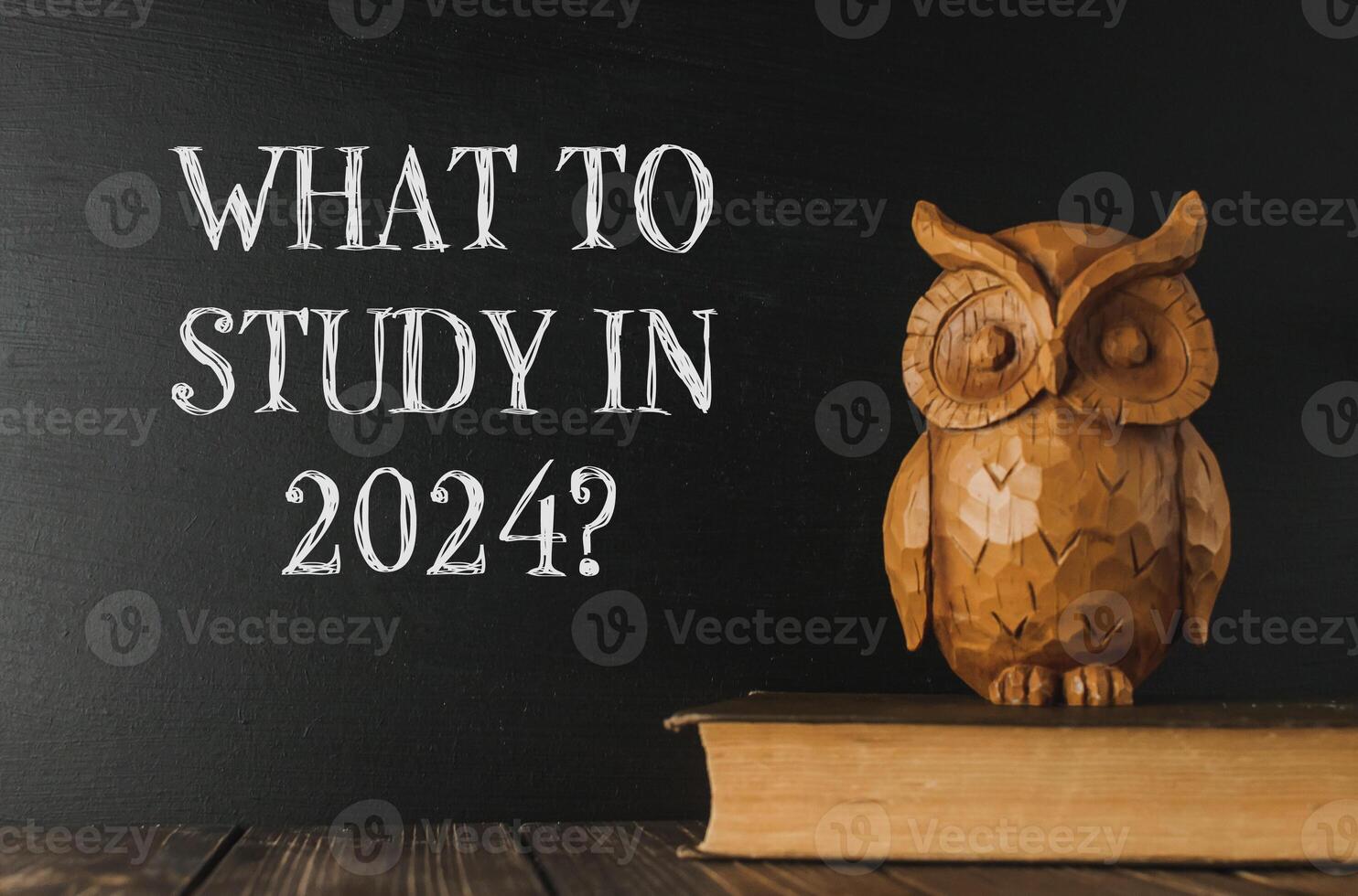 a book next to a chalkboard that says What to Study in 2024 photo
