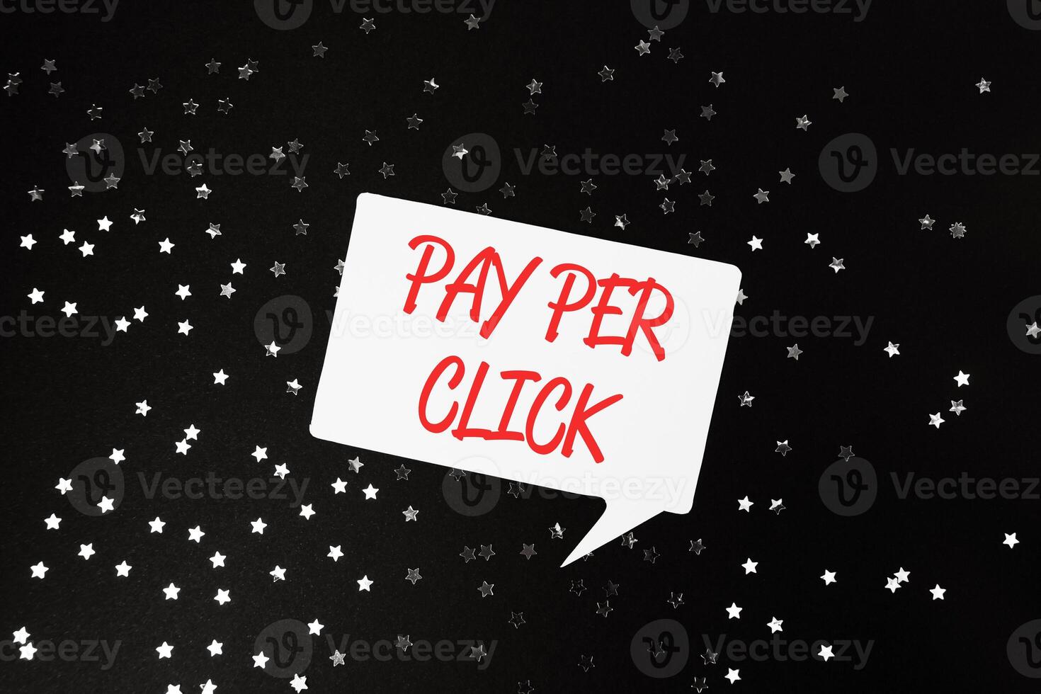 White and red sign that says pay per click is on a black background photo