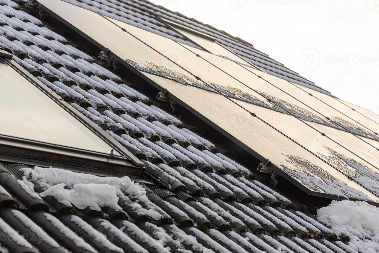 Solar panels produce electricity even in winter, efficiency decreases in winter due to snow and short daylight hours. Cold weather improves the performance of solar panels due to less overheating. photo