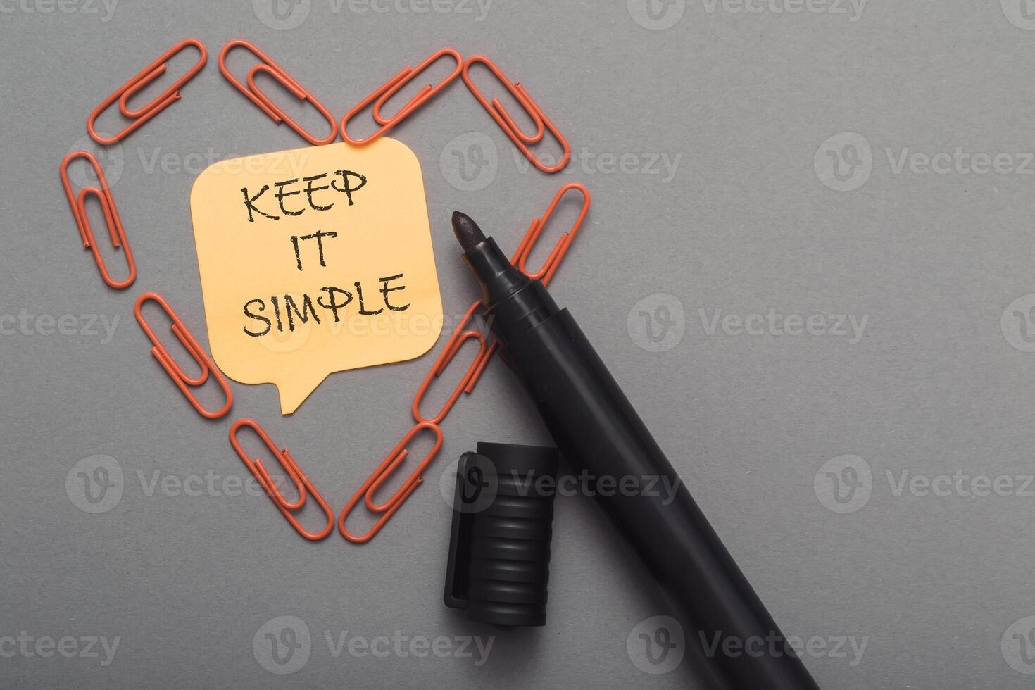 Keep it simple is written on a yellow sticky note photo