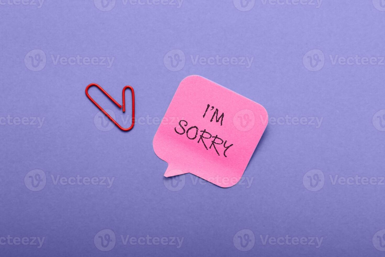 a blue background with a pink note that says I'm sorry. photo