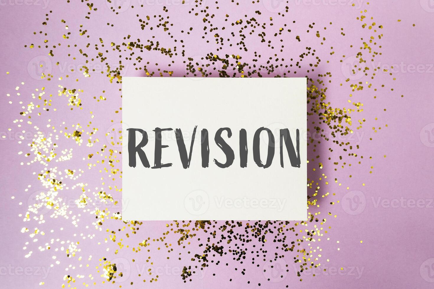 Revision is a word written on a white background with gold glitter photo