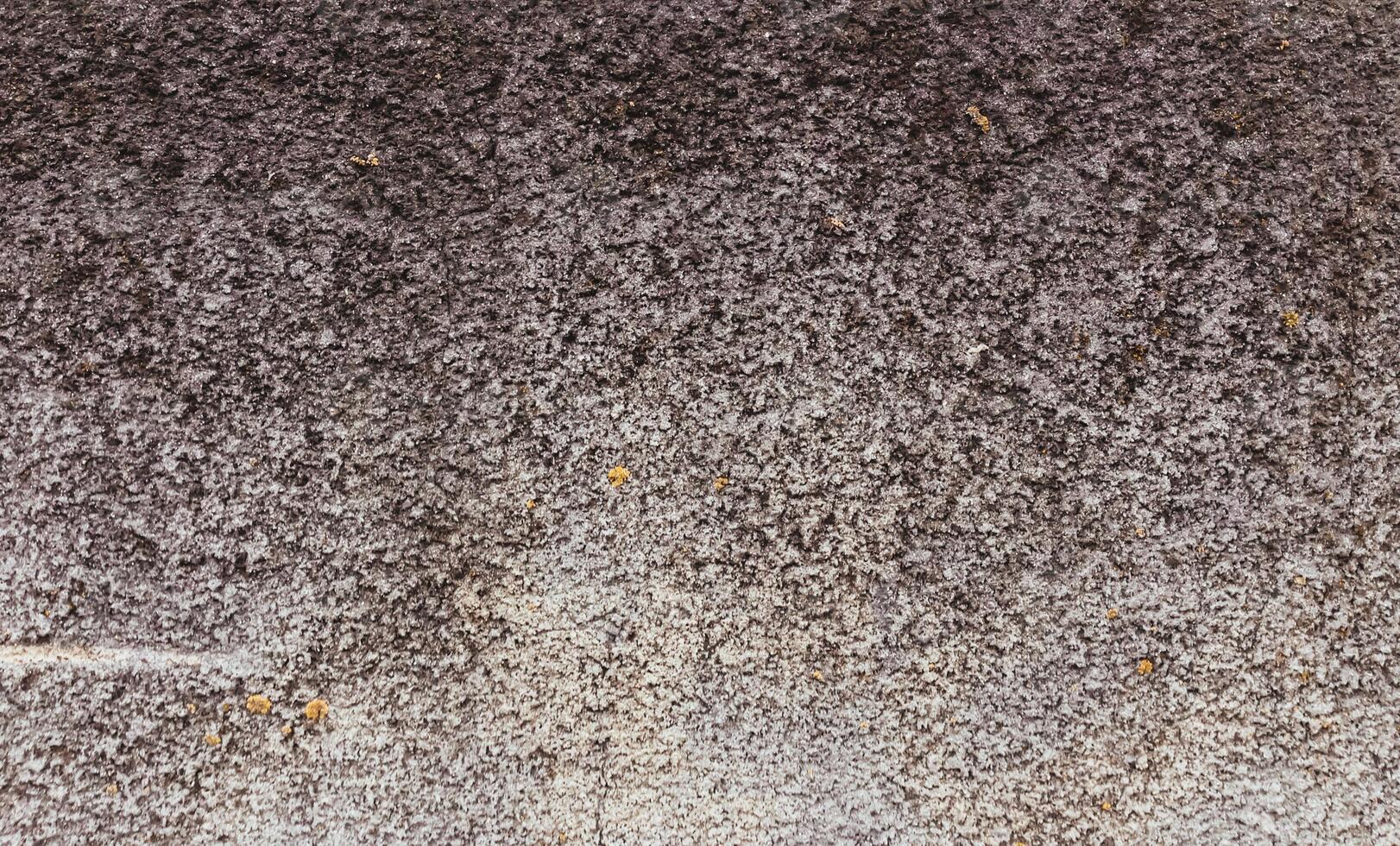 A grey and brown surface with a lot of texture photo