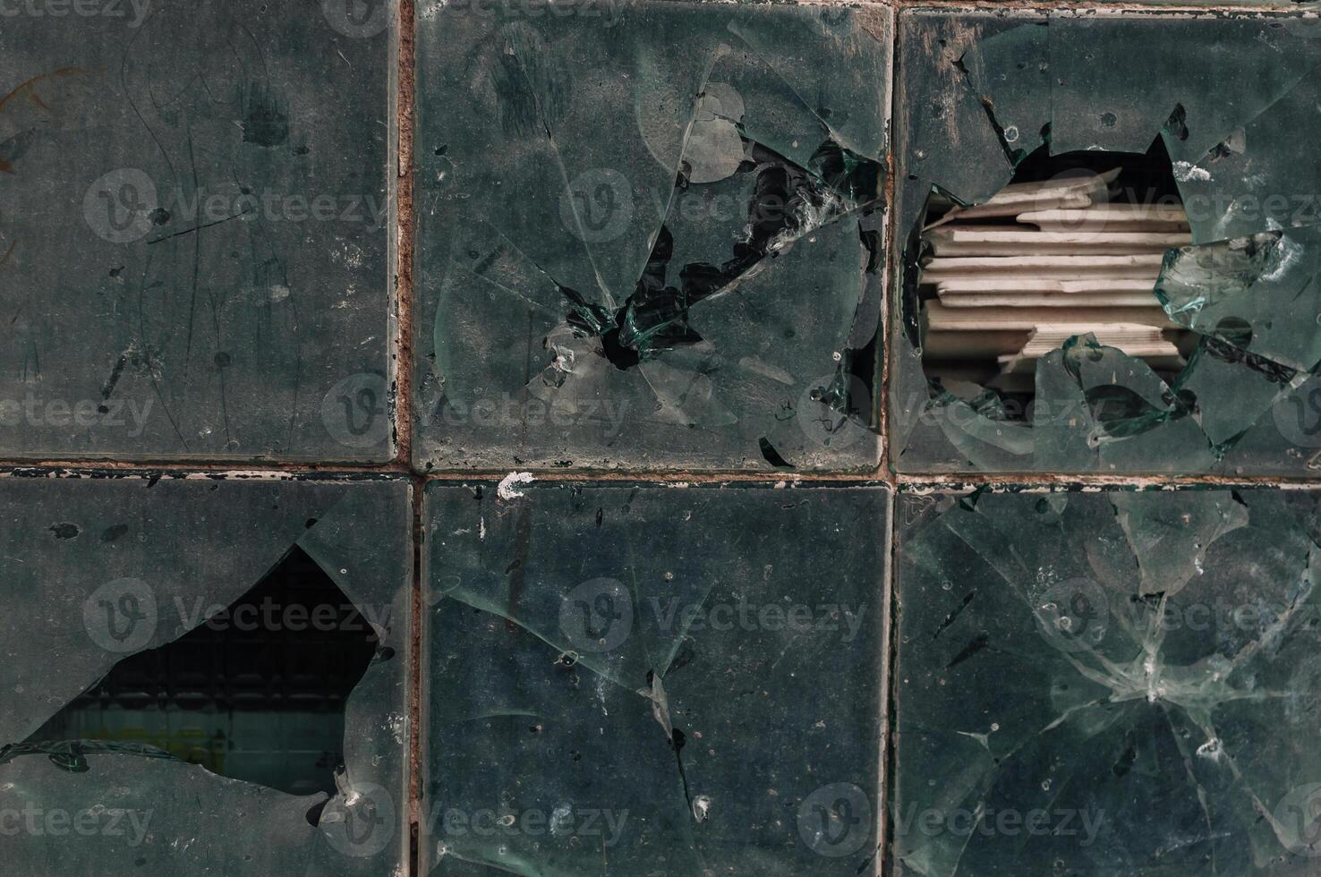 A broken window with a hole in it photo