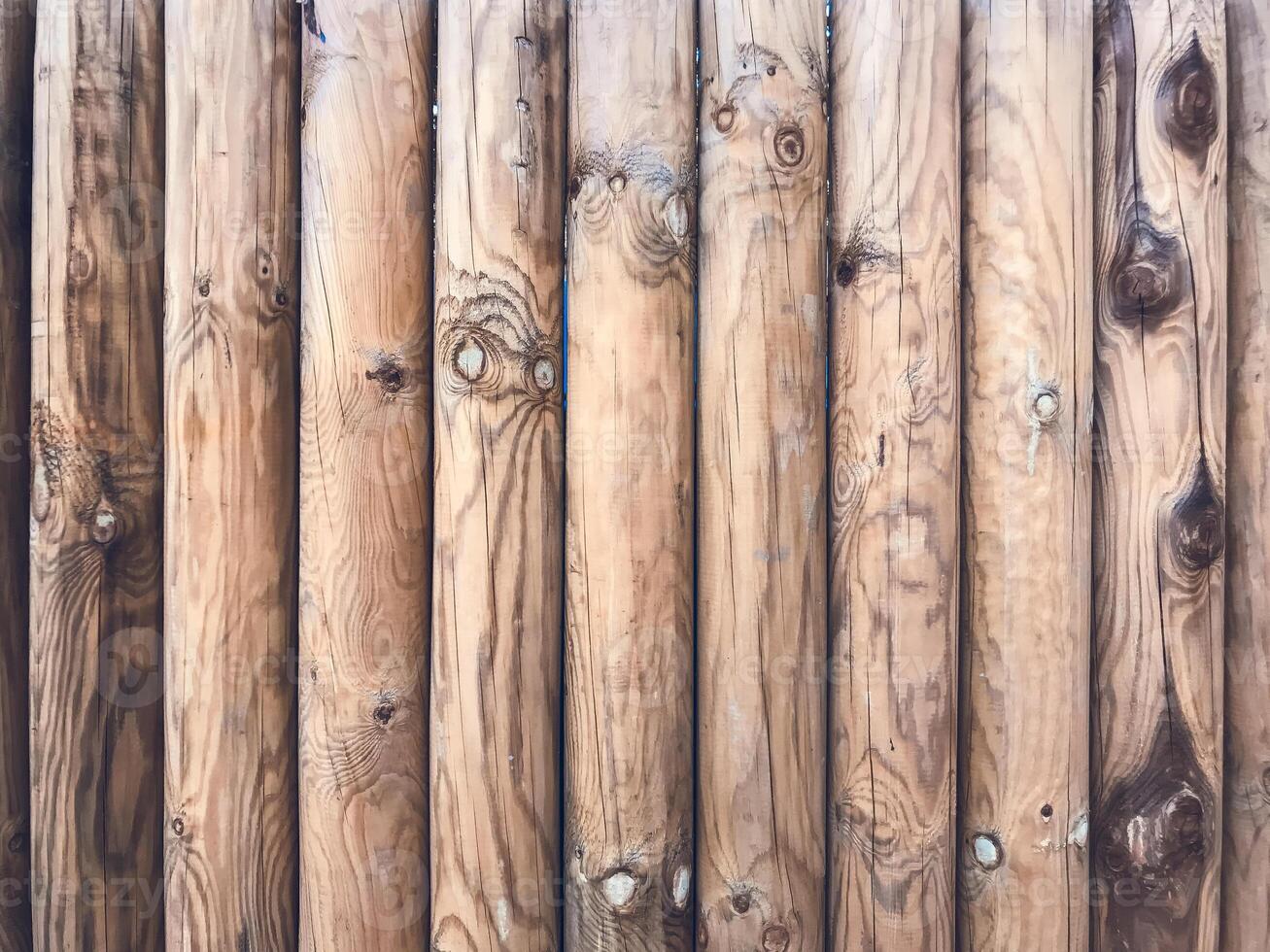 A row of wooden posts with a grainy texture photo