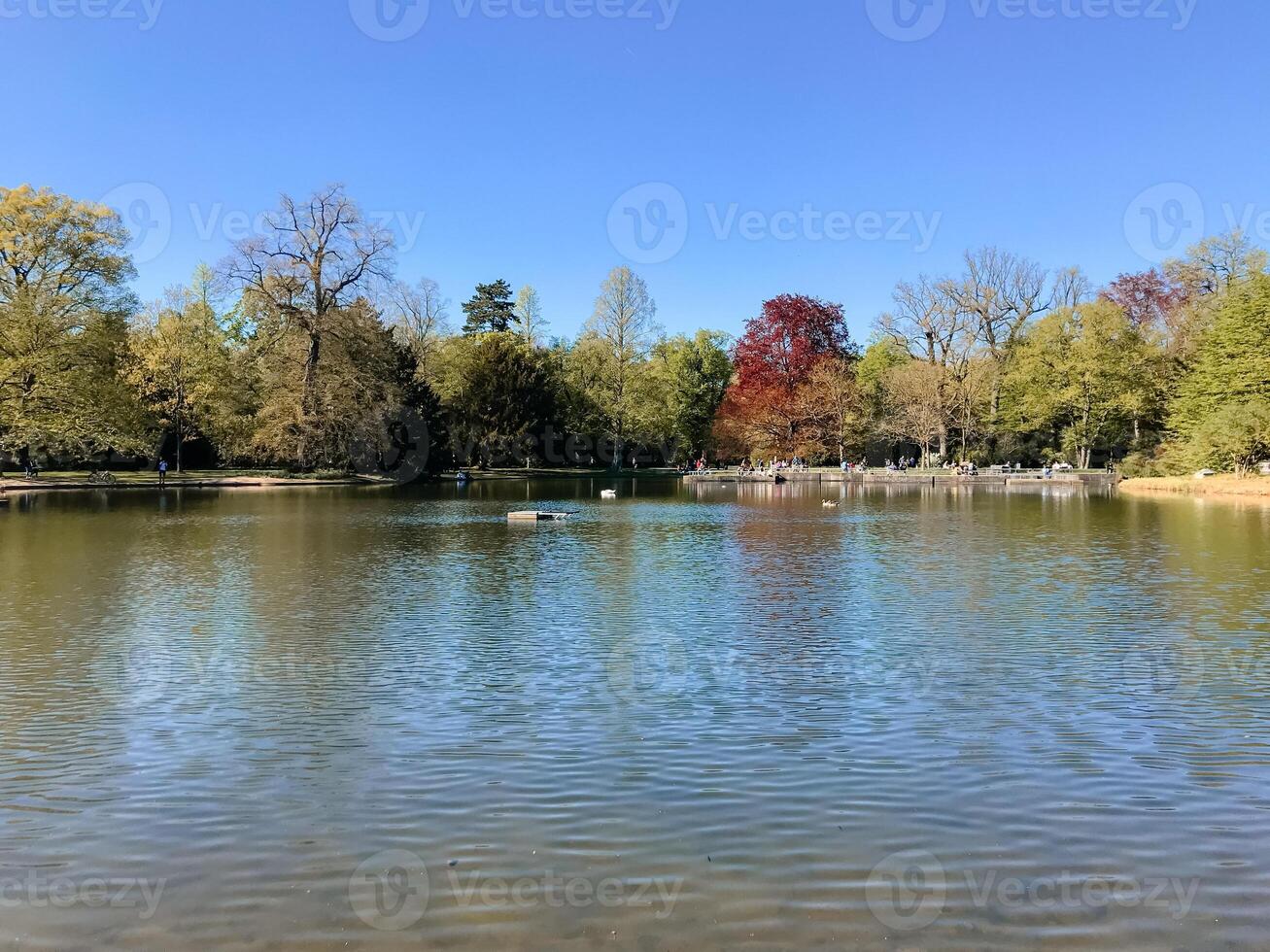 A lake with a few people in the background photo