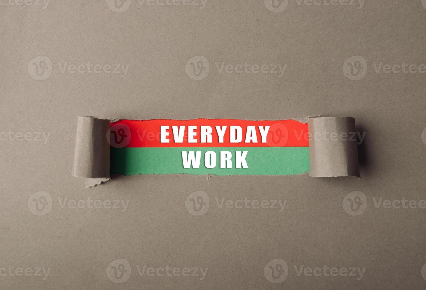 Piece of paper with the words everyday work written on it photo
