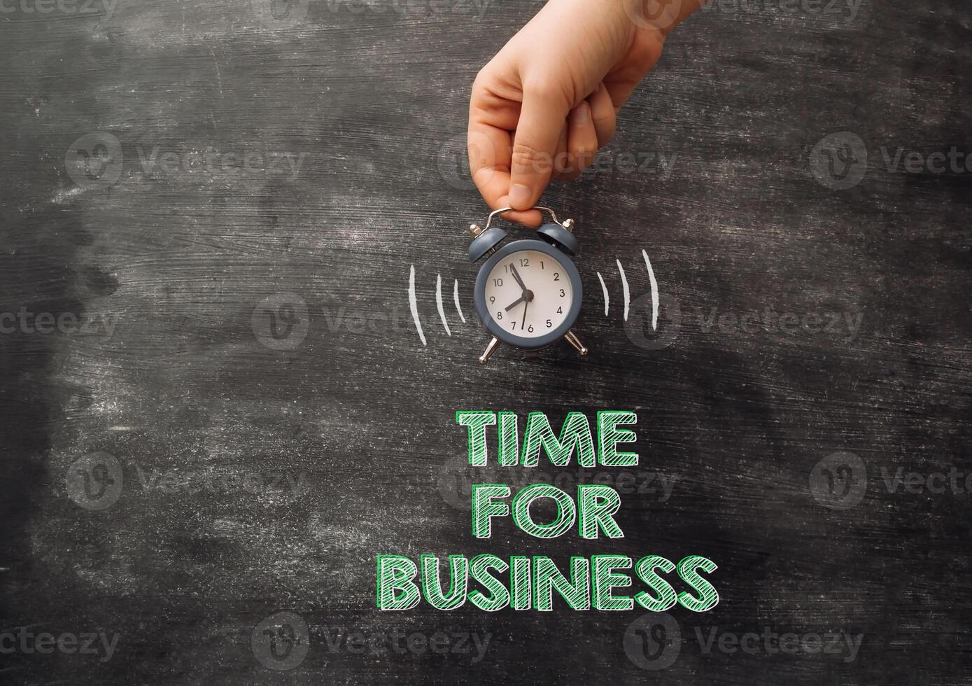 Person holds ringing alarm over words Time for Business photo