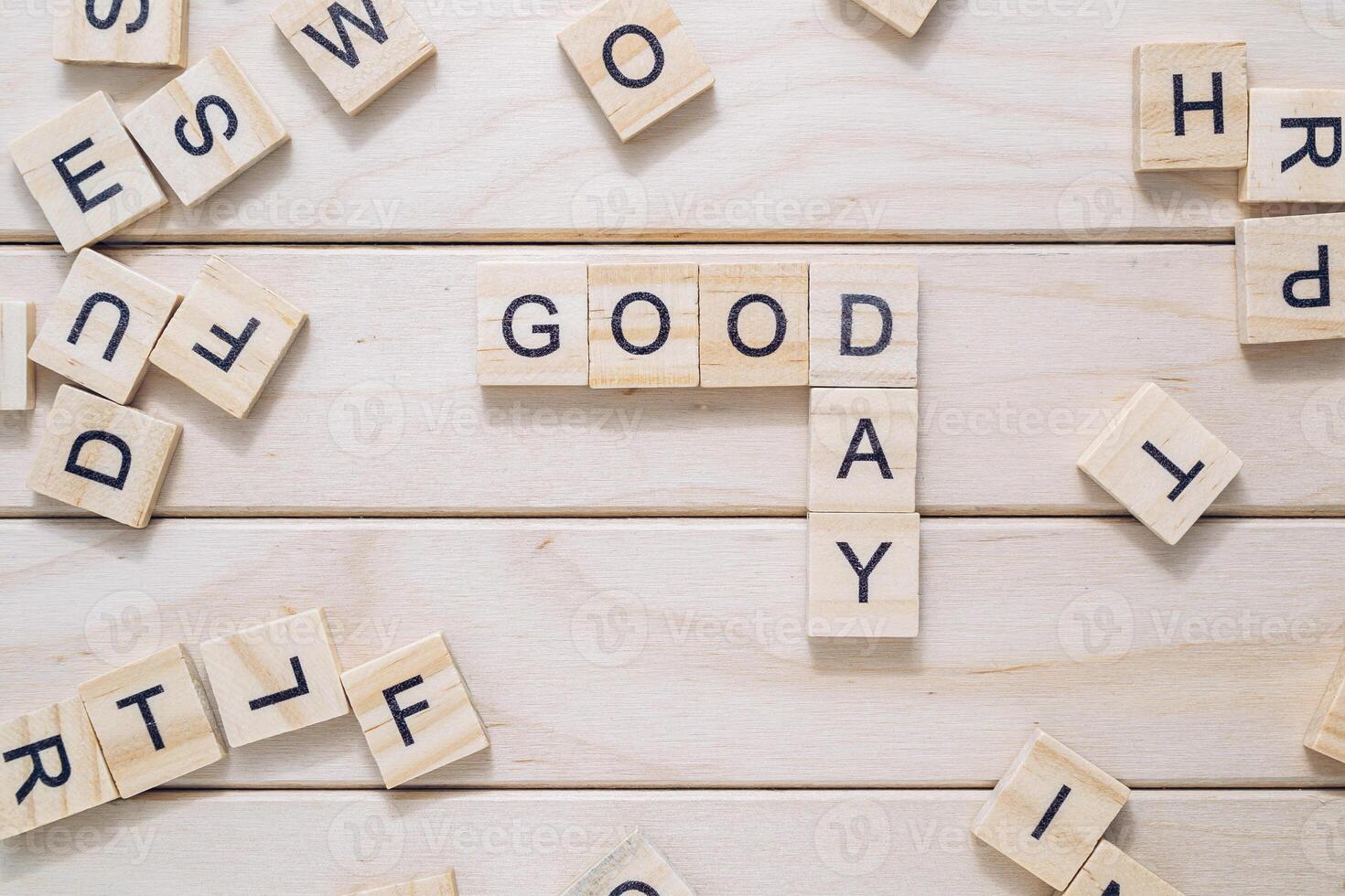 A jumble of wooden letters spell out the word good day photo