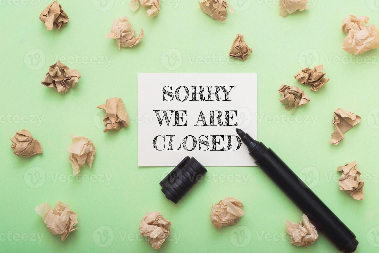 Sorry we are closed sign on a green background with a marker photo