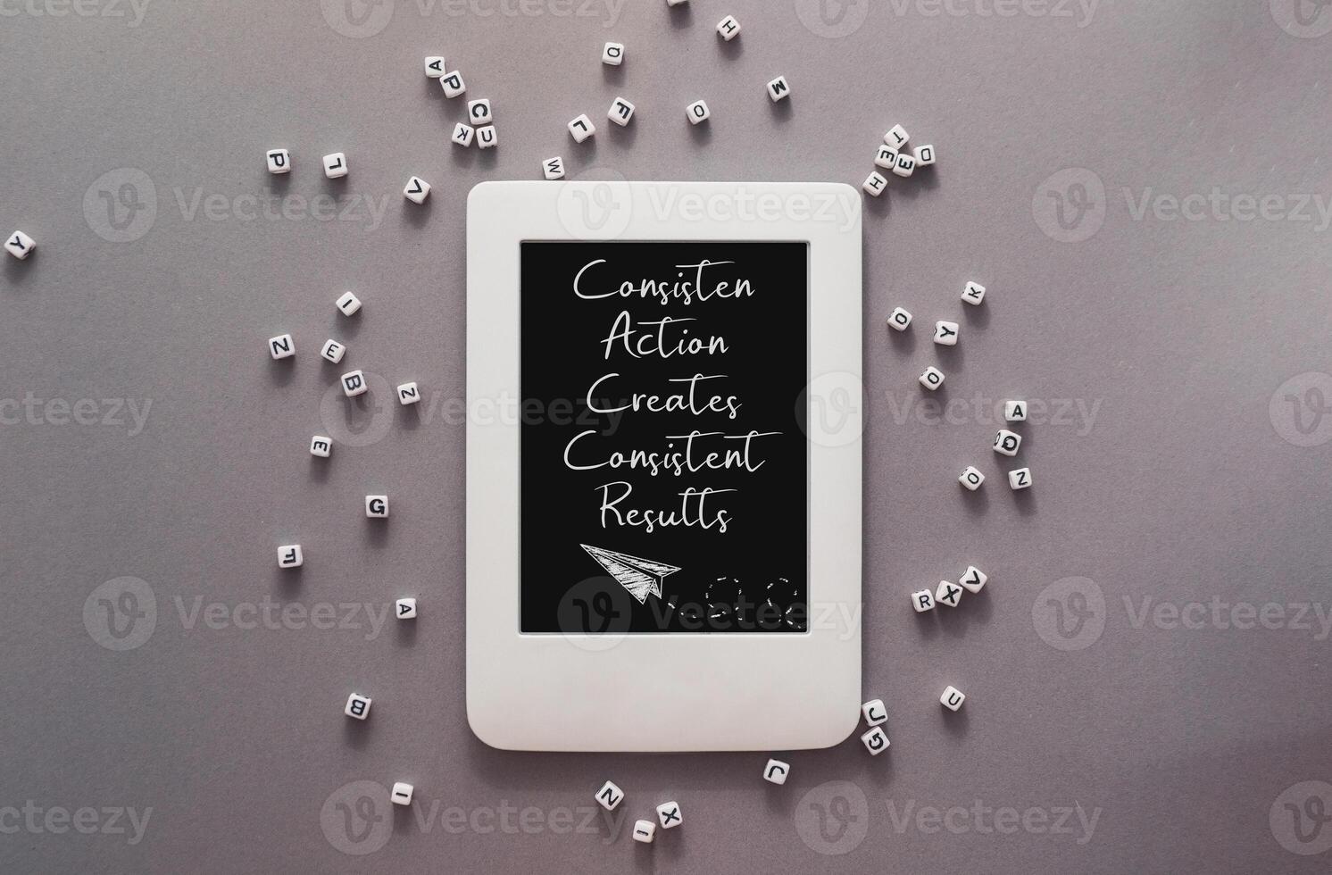The tablet is surrounded by a pile of white cubes photo