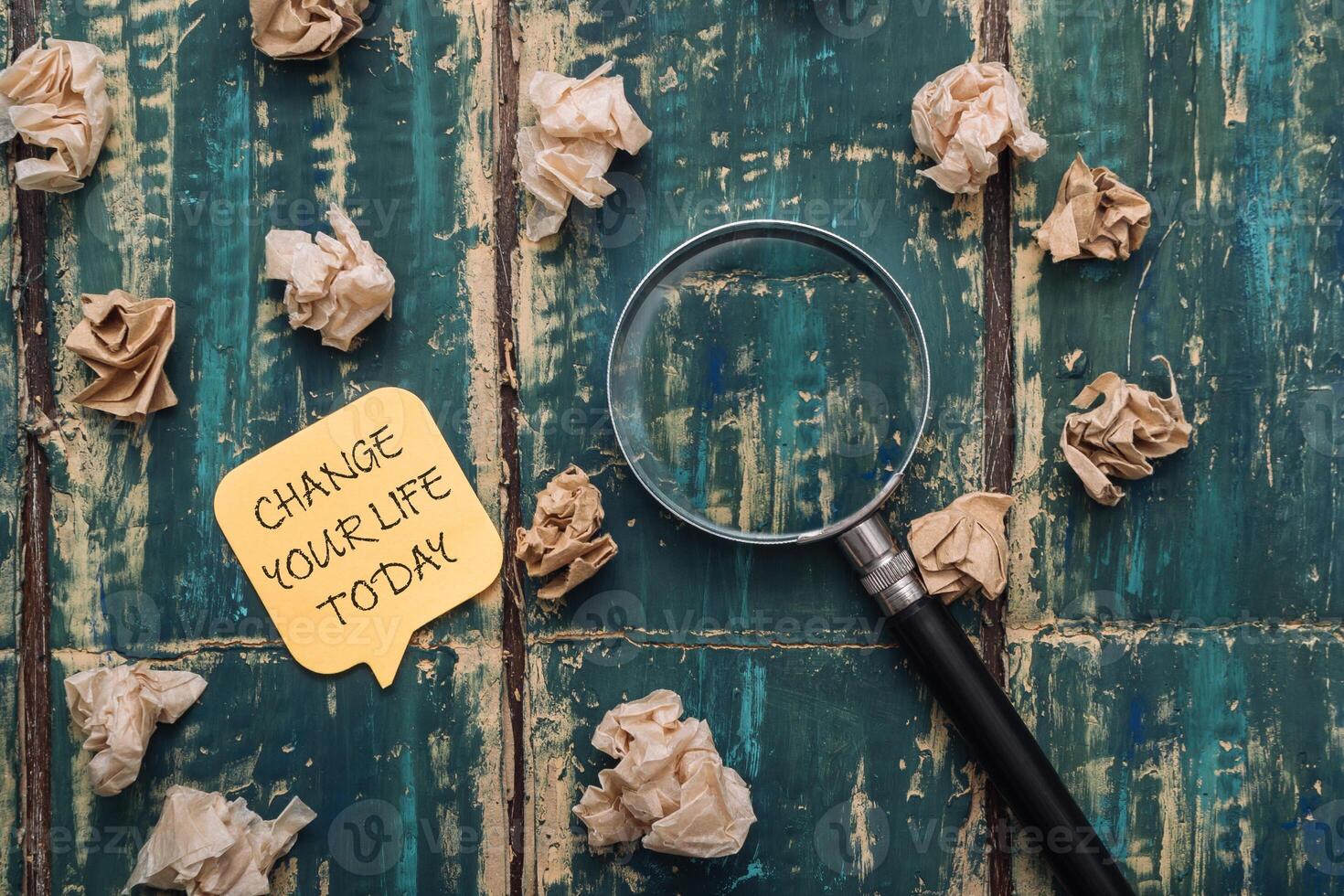 a pile of paper with the words change your life today photo