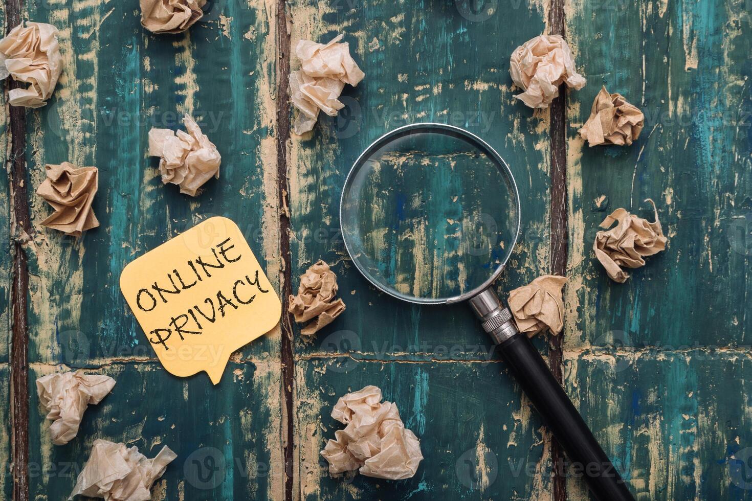 Yellow post it that says online privacy is on top of a pile of paper photo