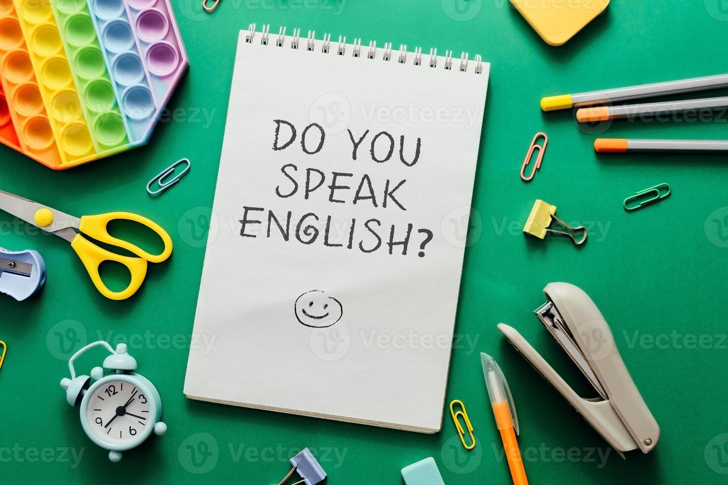 A notebook with the words Do you speak English written on it photo