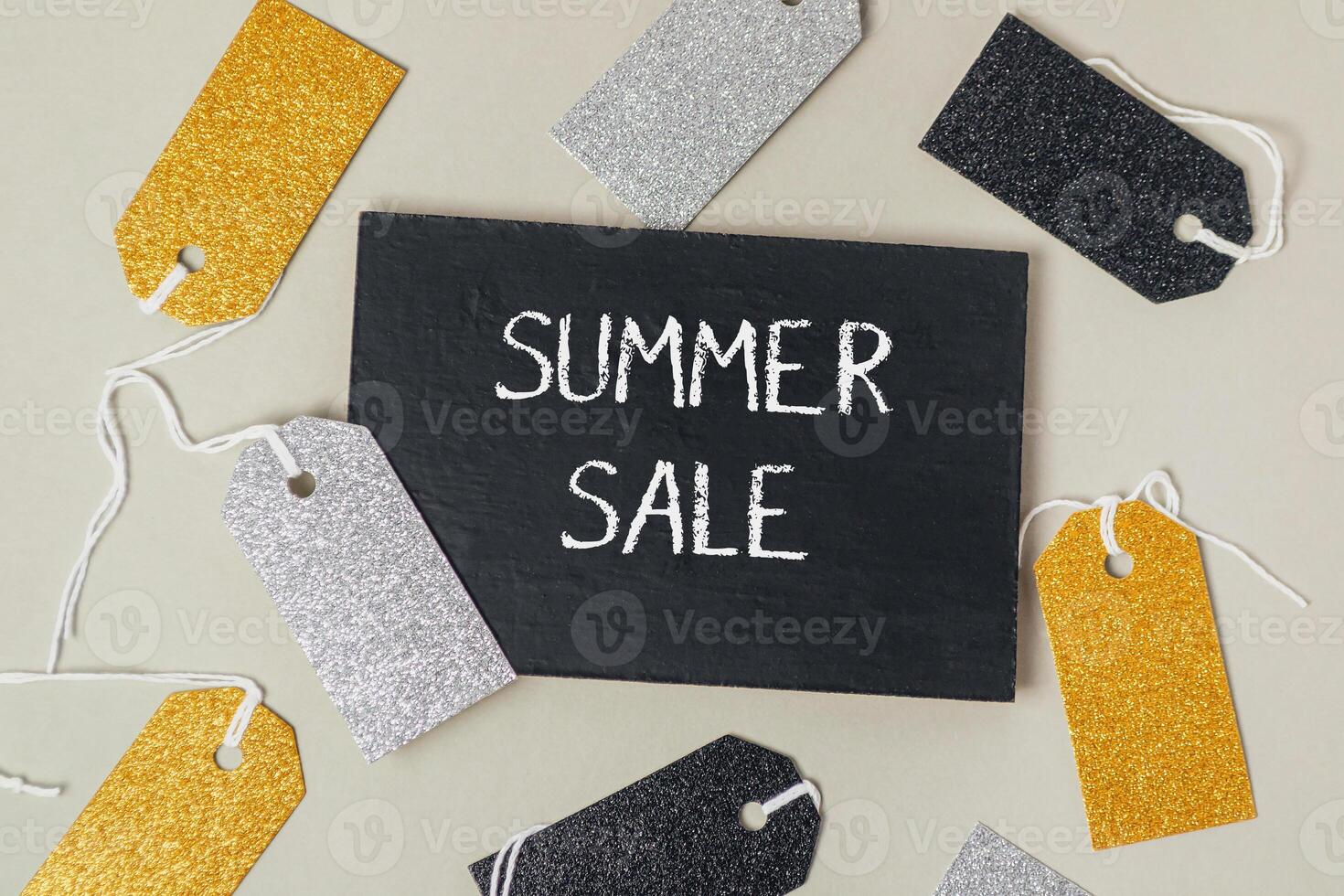 A black sign with the word Summer Sale written on it photo